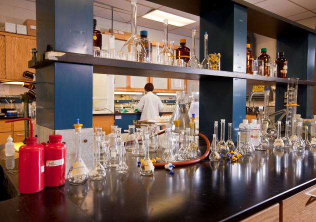 Photo: a row of laboratory bottles next to one another on a lab bench