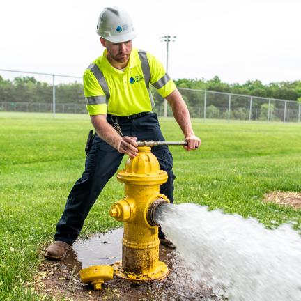 Employee Turning on Water Hydrant 