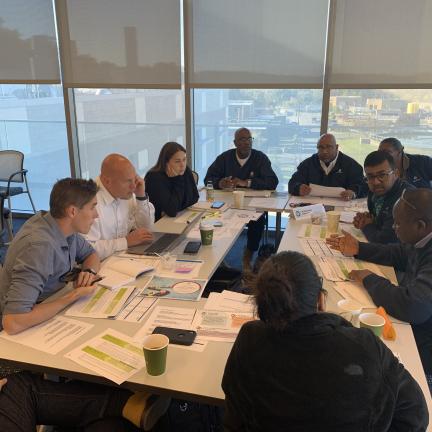 Photo: a group of employees at a table.