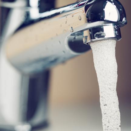 Photo: a close up shot of a faucet with water flowing out of it