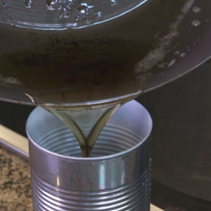 Grease being poured into a can
