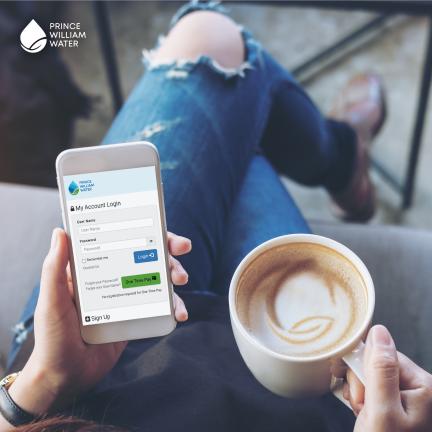 A person sitting drinking coffee with the Prince William Water mobile app pulled up on their phone