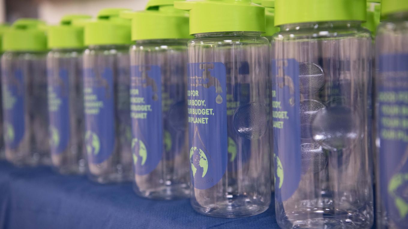 Reusable water bottles lined up on a table