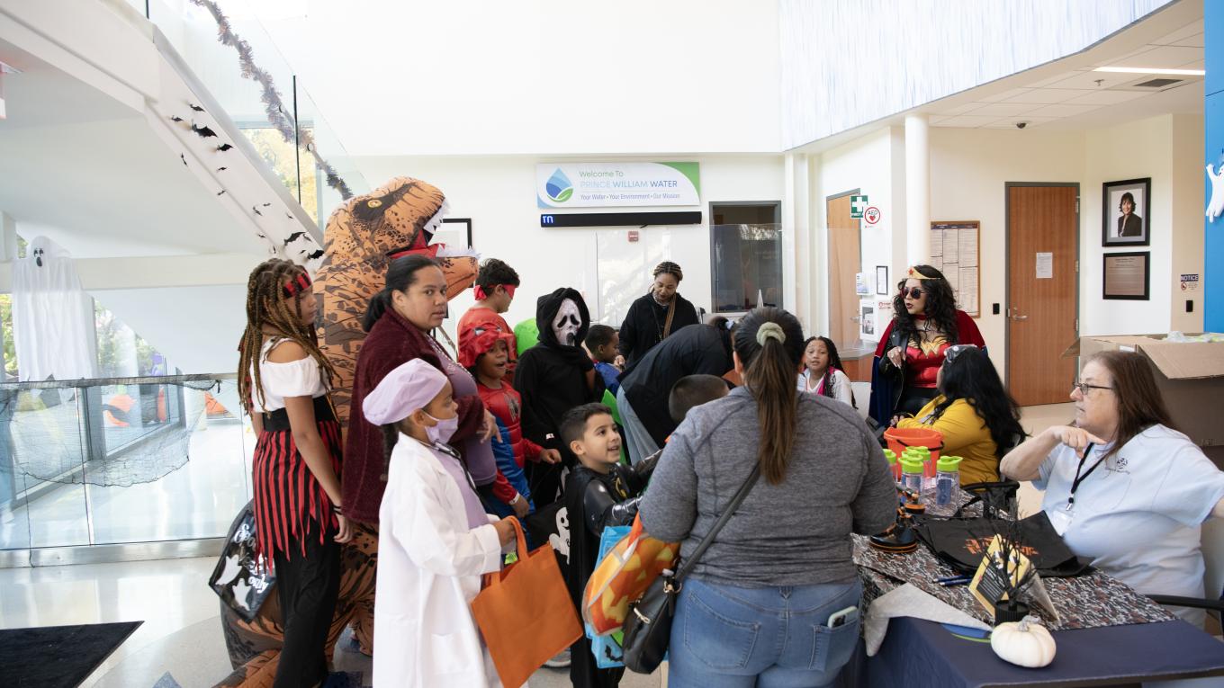 Individuals trick or treat at a Halloween-themed event