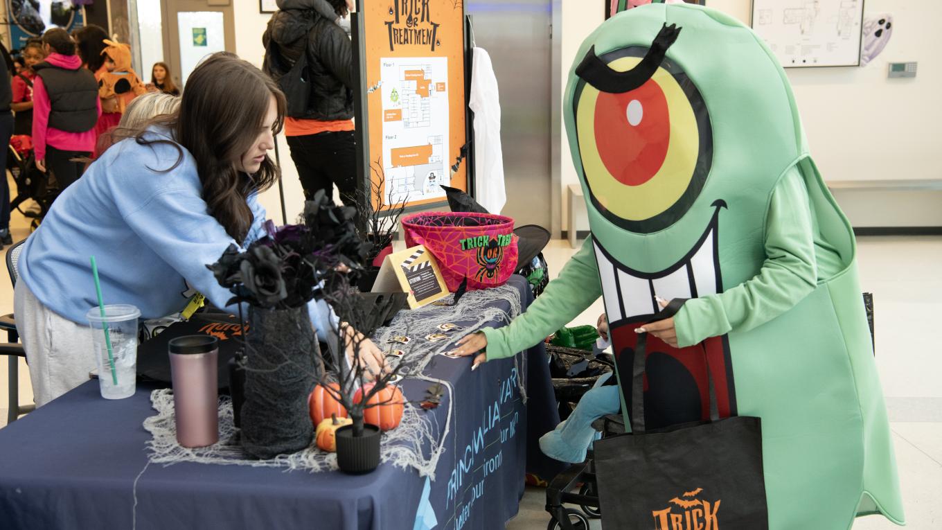 Individuals in costume gather at a Halloween-themed event