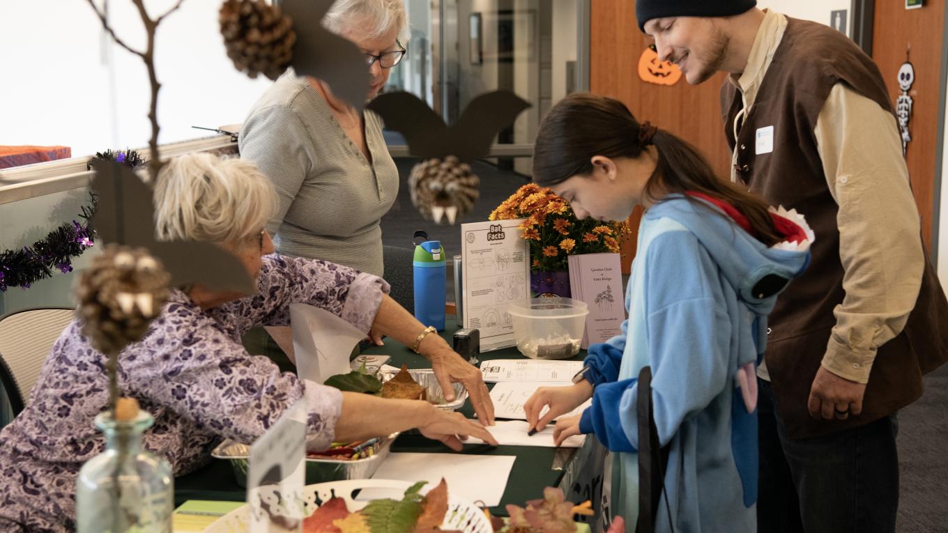 A child visits a table at a Halloween-themed event