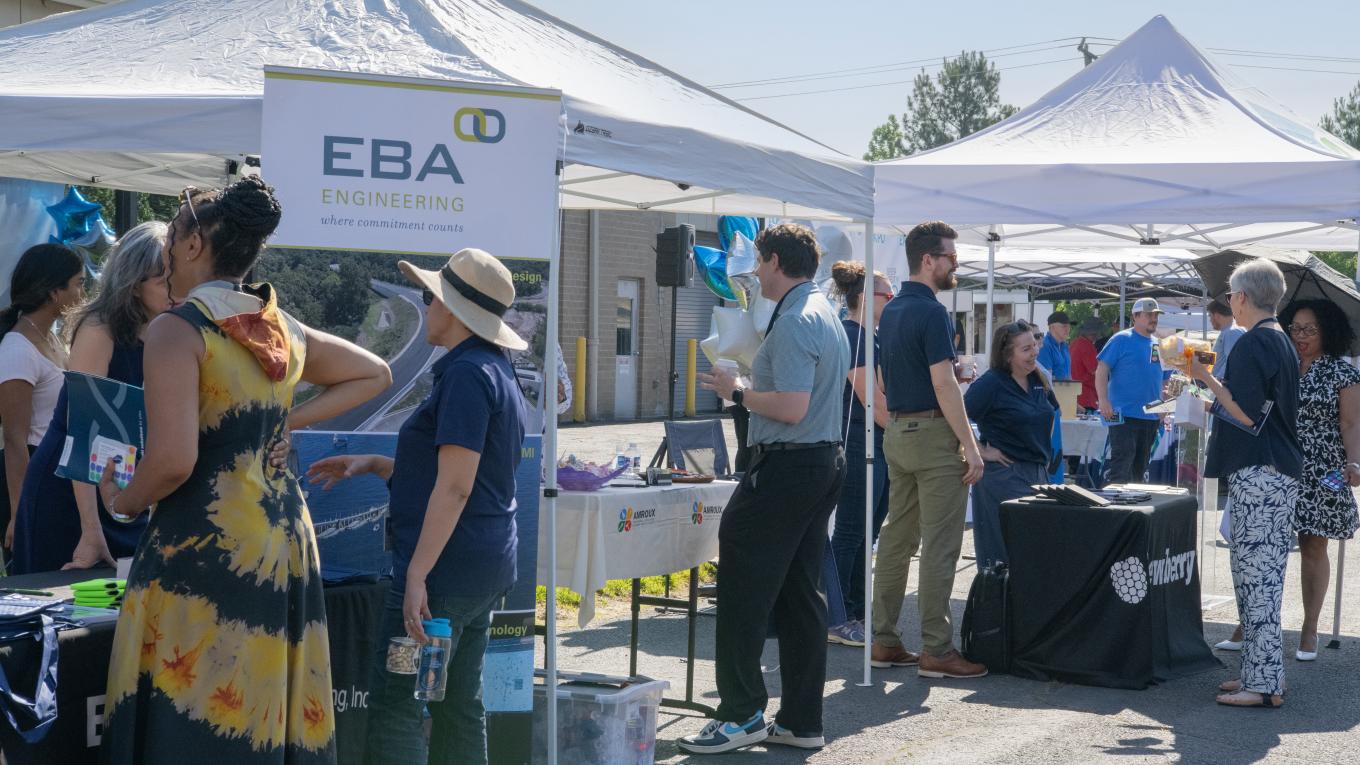 Prince William Water employees gather and talk with vendors under tents at the 2026 Supplier Diversity Expo