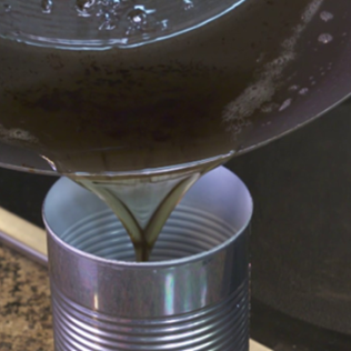 Grease being poured into a can