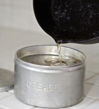 Photo: pouring grease into an aluminum can