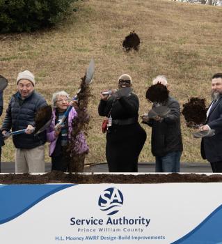 Photo: individuals tossing dirt with shovels at a groundbreaking ceremony