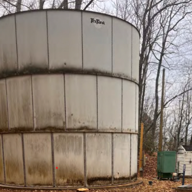 A large, aged water tank.