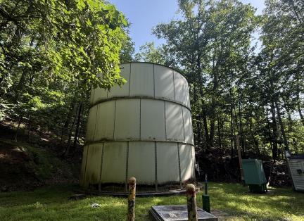 Ridge Road water tank standing among greenery