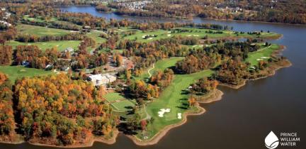 An aerial view of a golf course next to a lake