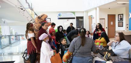 Individuals trick or treat at a Halloween-themed event