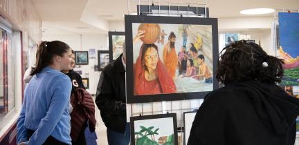 Individuals mingle and view artwork at the 2026 Water Art Invitational