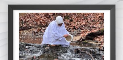 Artwork of a woman pouring a bucket of water into a creek