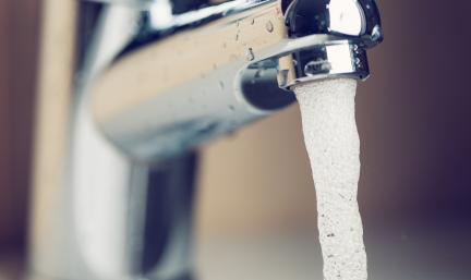 Photo: a close up shot of a faucet with water flowing out of it