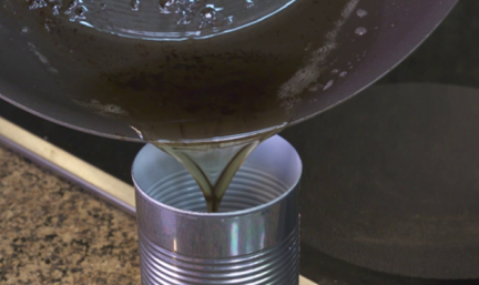 Grease being poured into a can
