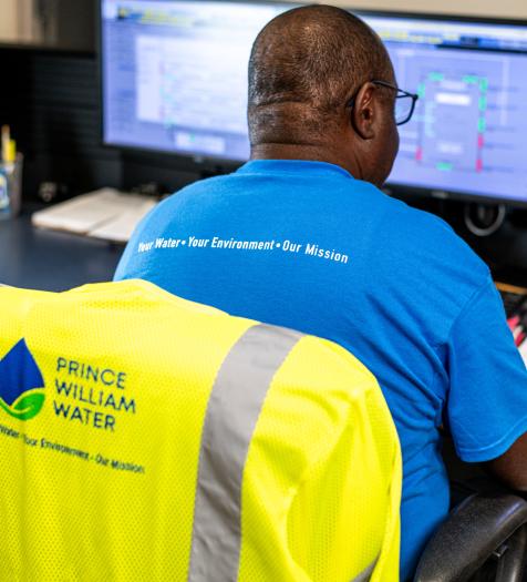 Photo: a water reclamation operator viewing computer screens.