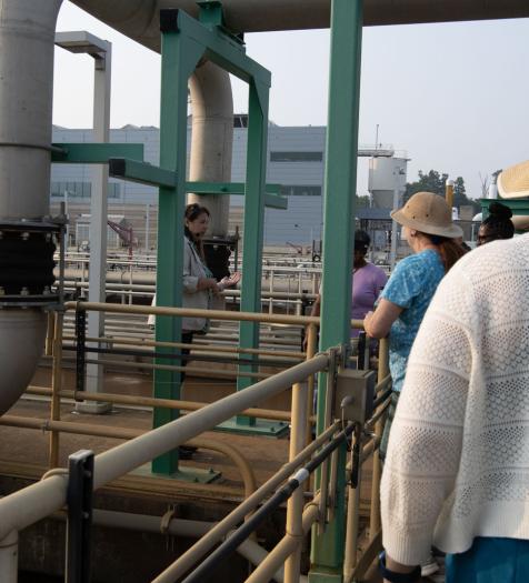 Photo: individuals taking a tour of a wastewater treatment facility