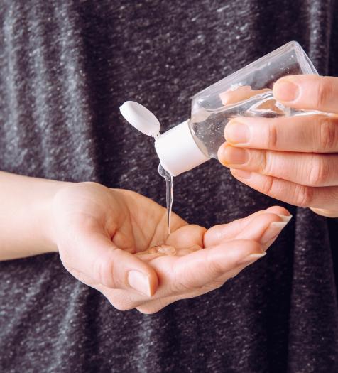 Photo: a person putting hand sanitizer into their hand