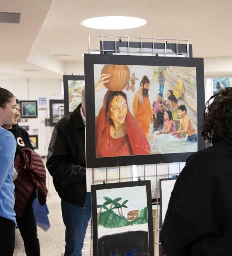 Individuals mingle and view artwork at the 2026 Water Art Invitational